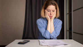 Homeowner reviewing a utility bill at a kitchen table