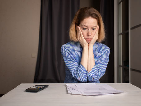 Homeowner reviewing a utility bill at a kitchen table