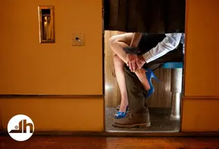 Couple embracing in a photo booth, photograph by Casey Templeton.