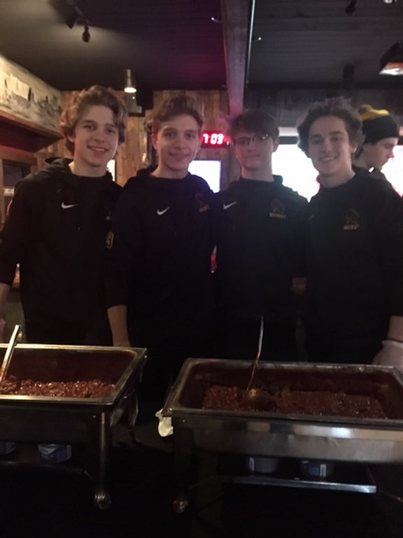 Chase Kvaal, Kevin Kvaal, Tyler Chamberlain, Darby Hanson serving chili