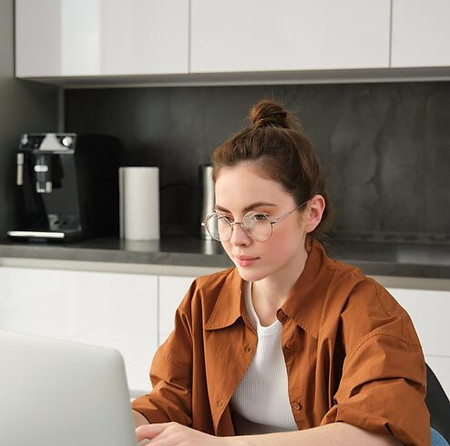 vertical-shot-woman-working-from-home-business-owner-using-laptop-browsing-social-media_12