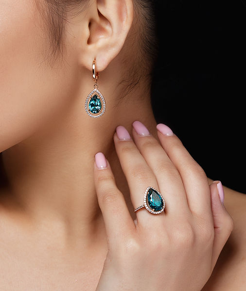 model-shows-earrings-ring-with-beautiful-blue-precious-stones.jpg