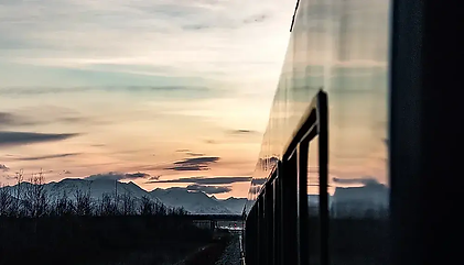 Alaskan train on Alaskan railroad in the sunset