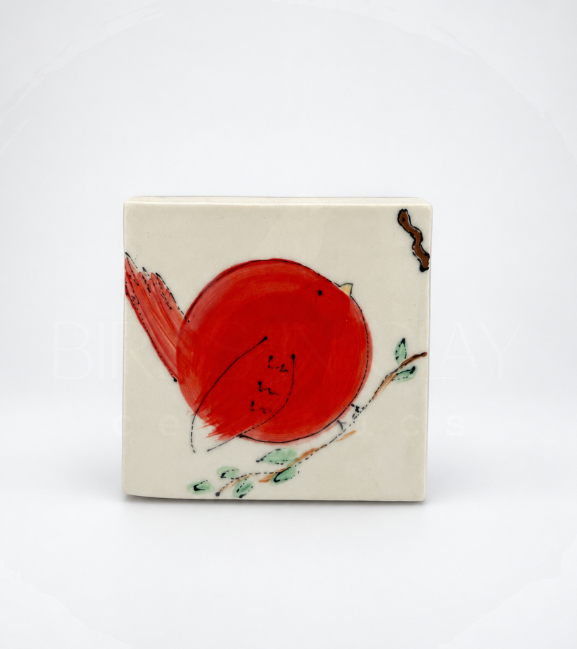 chonky red bird on porcelain tile