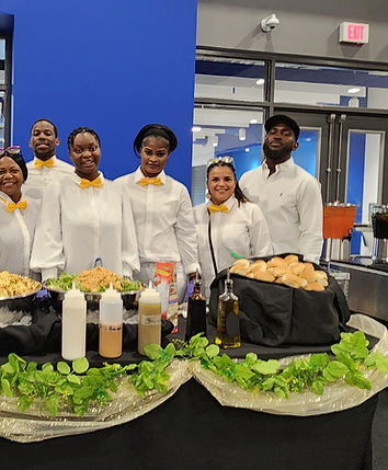 Staff with catering display.jpg