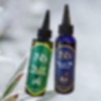 Dropper bottles of the JNJS's Nourish Mi Growth Oil and the JNJS's Itchy Scalp & Dandruff Treatment Oil.