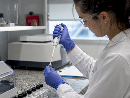 Lab technician pipetting analyte for LOD/LOQ test