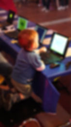 Ein 3 jähriges Kind, das an einem Laptop ein Game ausprobiert
