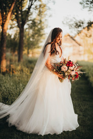 a bride looking at she bouquet in Nanton, AB. 
