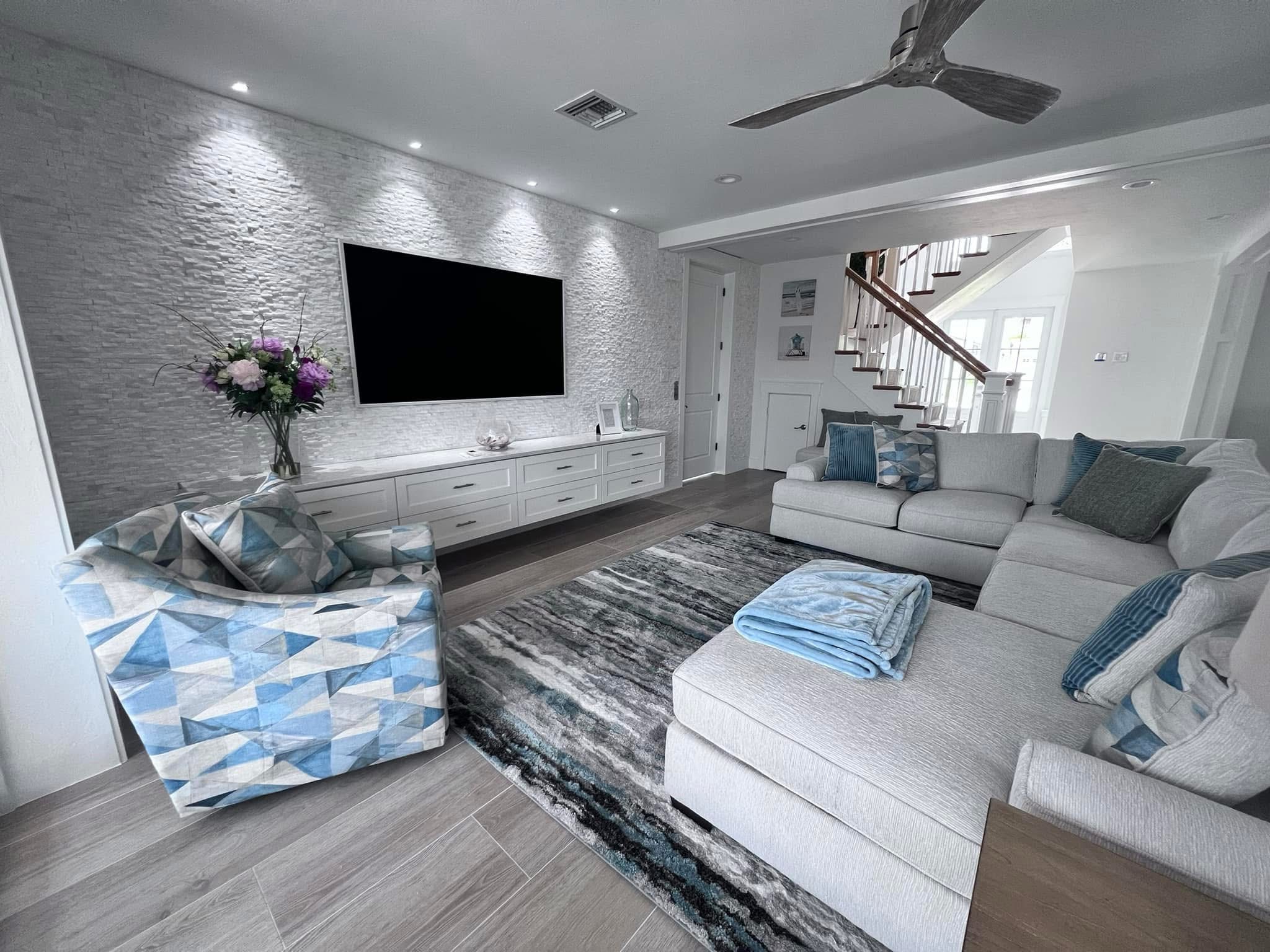 Living room with feature wall, Naples area home by Coastal Custom Homes SWFL