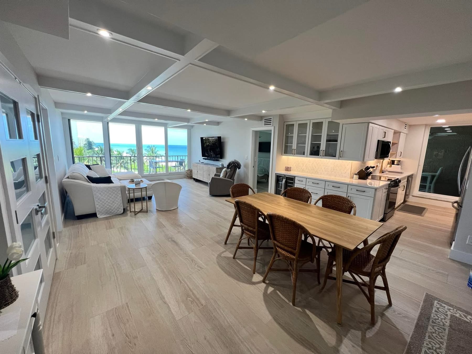 Open kitchen and dining area, Naples area home by Coastal Custom Homes SWFL