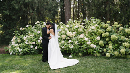 Bride and Groom having a moment in front of hydrangeas