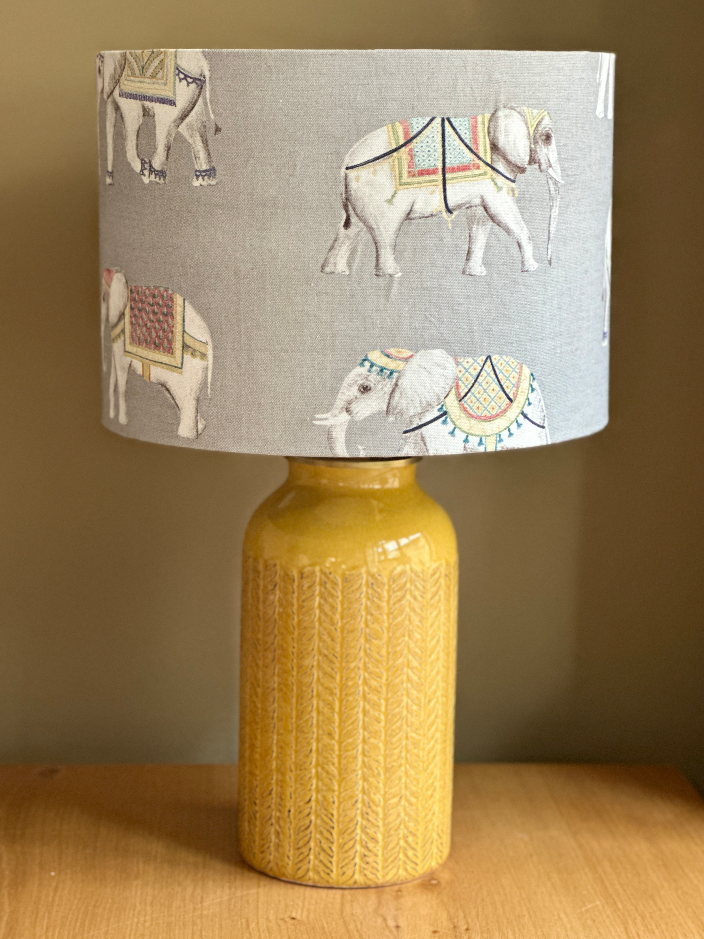 Mustard ceramic lamp base with carved leaf pattern, paired with an exotic fabric feauturing indian elephants