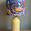 Thumbnail: Mustard ceramic lamp base with carved leaf texture and a linen fabric lampshade featuring blue and mustard design