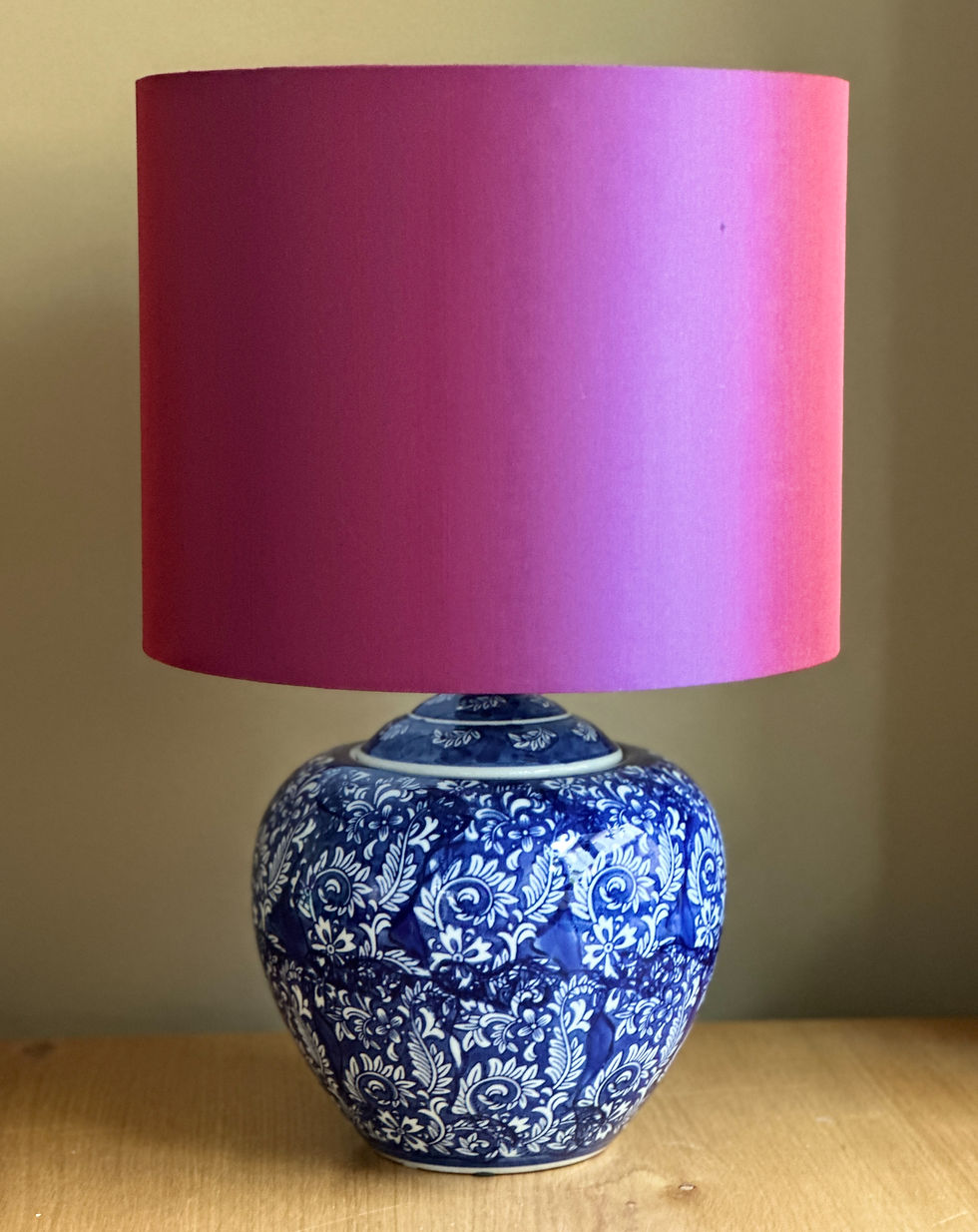 Porcelain lamp with a deep blue and white floral damask base, paired with a satin bold bluish-purple shade