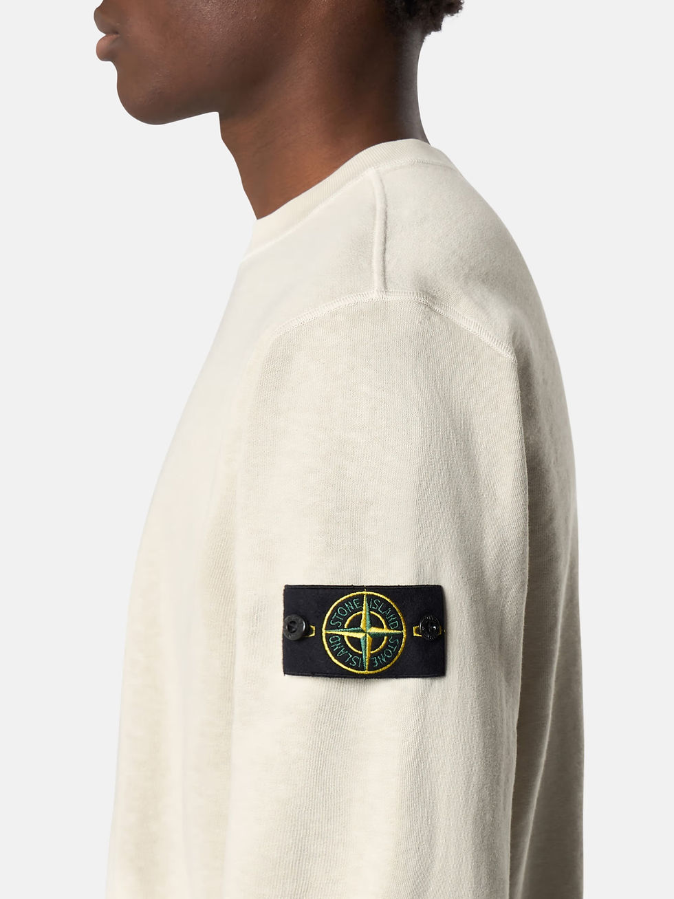 Miniature : Homme portant un pull beige Stone Island avec logo, Boutique Karsenty.