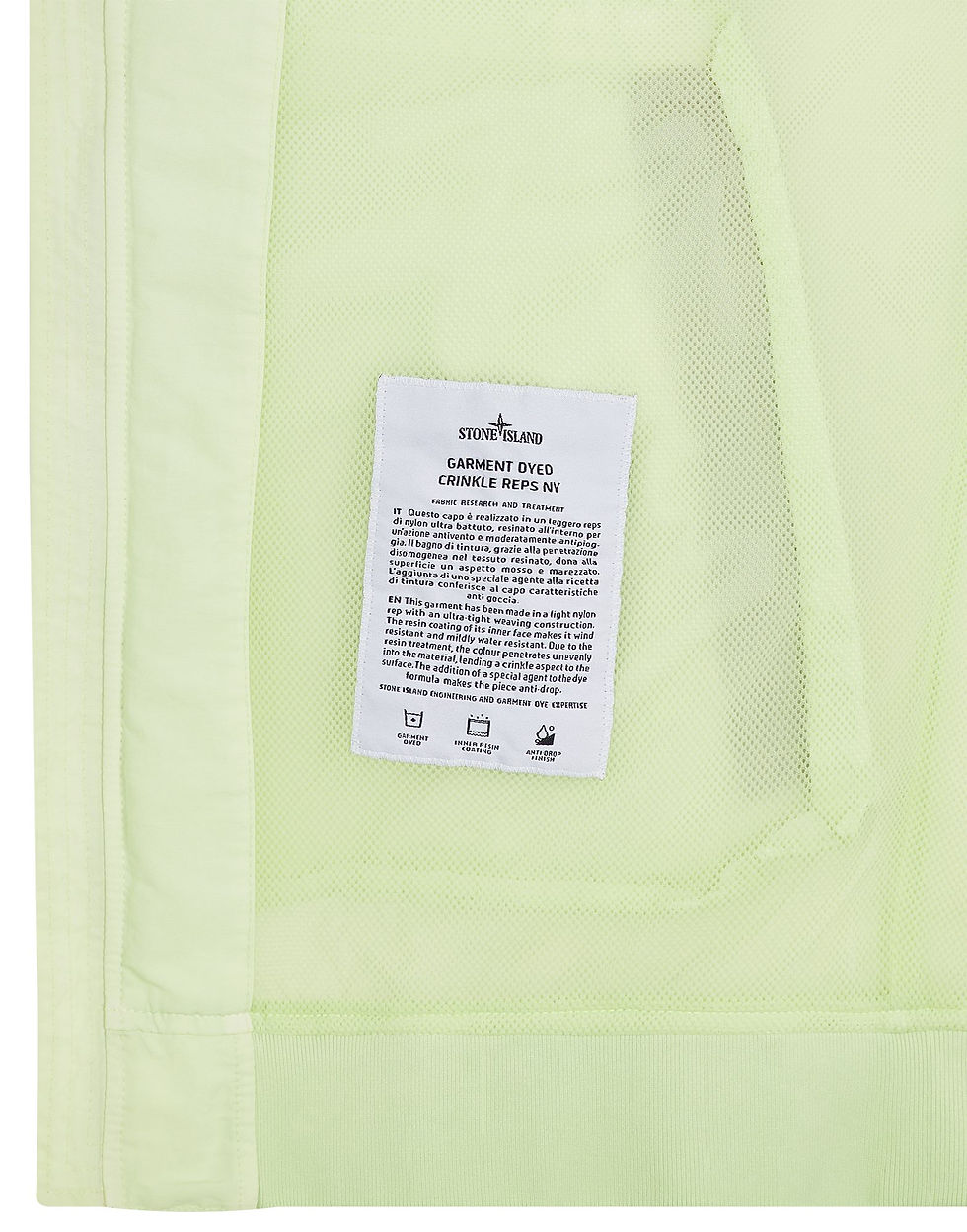 Miniature : Gros plan d'une étiquette Stone Island sur fond vert clair, détails du produit.
