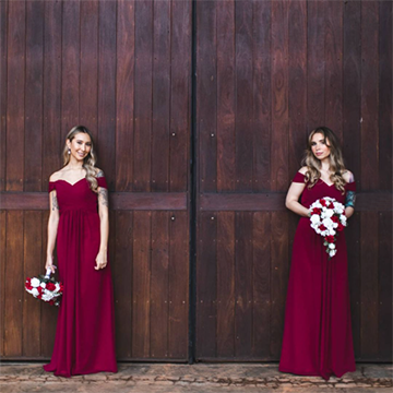 A Caucasian woman with blonde hair in a maroon dress stands in two poses against a dark wood background: The left pose holds her white and maroon bouquet down at her side and the right-hand side holds the bouquet in front of her belly.