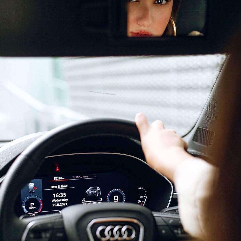 Successful woman driving Audi by hosting her other cars