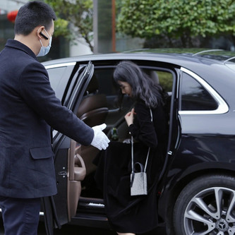 Chauffeur driver dropping off client of the vehicle