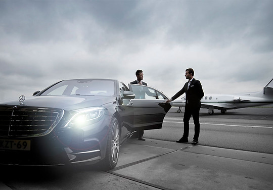 Driver and bodyguard drive client to airport for private jet