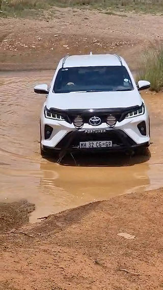White Toyota Fortuner entering water crossing during 4x4 Off-Road Training at Hennops River Valley with SA Adventure