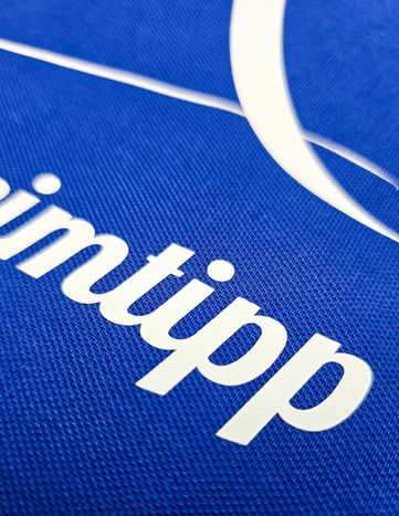 Flexfolie die auf einen groben blauen Leinenstoff heiß gepresst wurde. Bedruckung von Textilien, Schürzen, Shirts und anderes