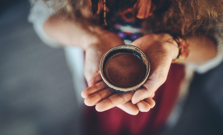 Cacao ceremony, heart opening medicine. Ceremony space. Cacao cup in woman's hand..jpg