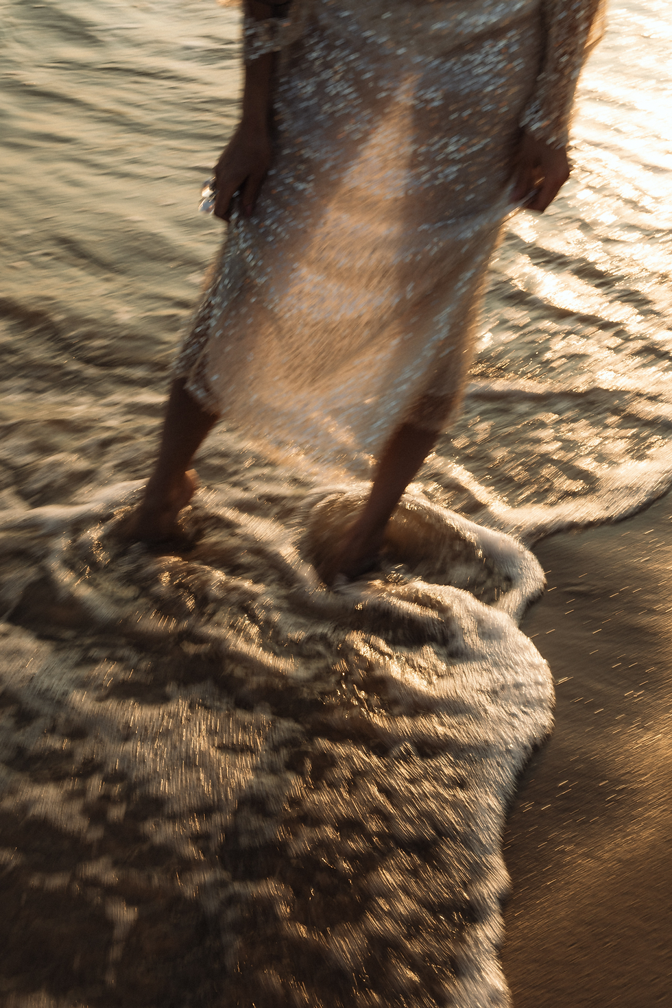 Woman standing in the ocean waves - Wellness Coach Psycology