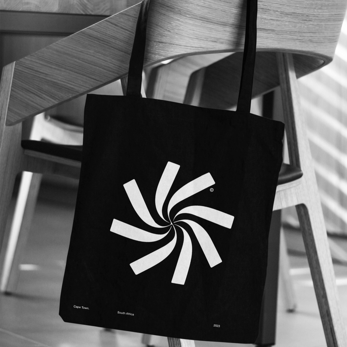 Ara Architecture minimal brand mark on canvas bag over wooden chair — premium visual identity for design studios