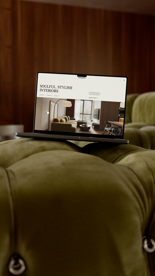 Studio Ákara website design mockup on laptop over luxury lounge suite — Wix Studio designer for interior designers