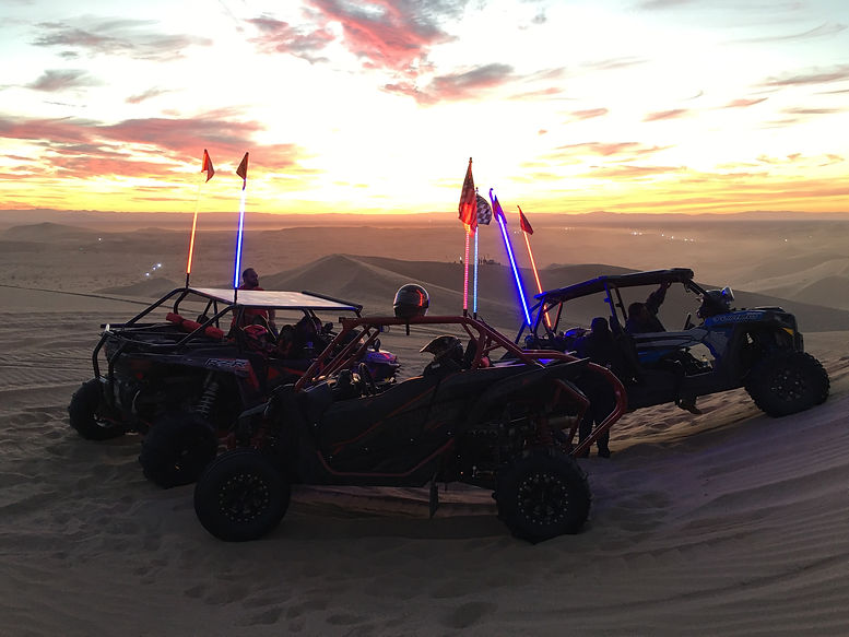 Line of UTVs in sand dunes