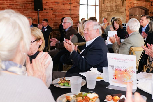 Attendees applauding at a table during Entrefest lunch event