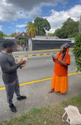 Akili Jamal Haynes aka Chibuzo Dunun and poet Denise Washington in front of Bob Marley's House on Hope Road in Jamaica.