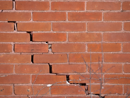 red brick home exterior with crack due to shifting foundation