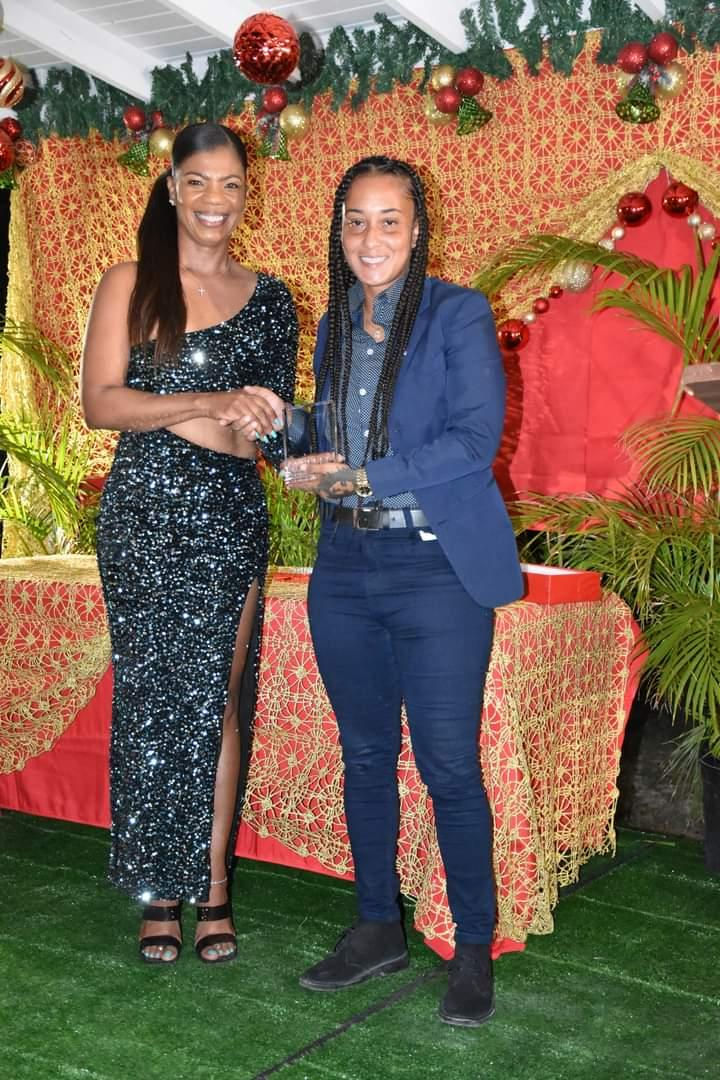 Olivia Gravely (right) collects her award for her work in football