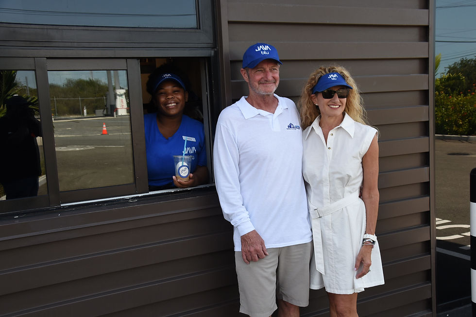 Carmela Giordano and husband Paul Horton join a staff at the drive-thru window for a photograph