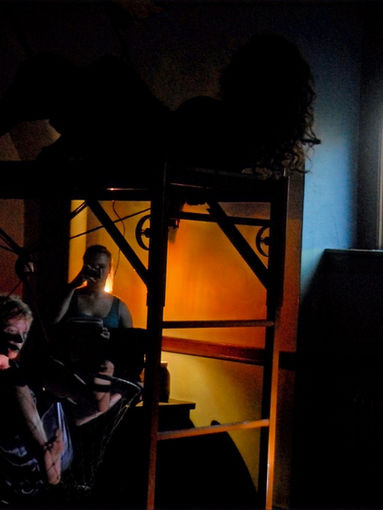 Racy Brand and Haas hanging off and dancing on scaffolding during a performance inside the Natural History Building at the University of Illinois Urbana-Champaign