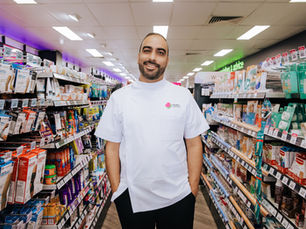 Man poses for a headshot in a pharmacy