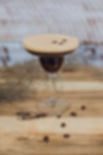 Espresso martini cocktail on a wooden bench