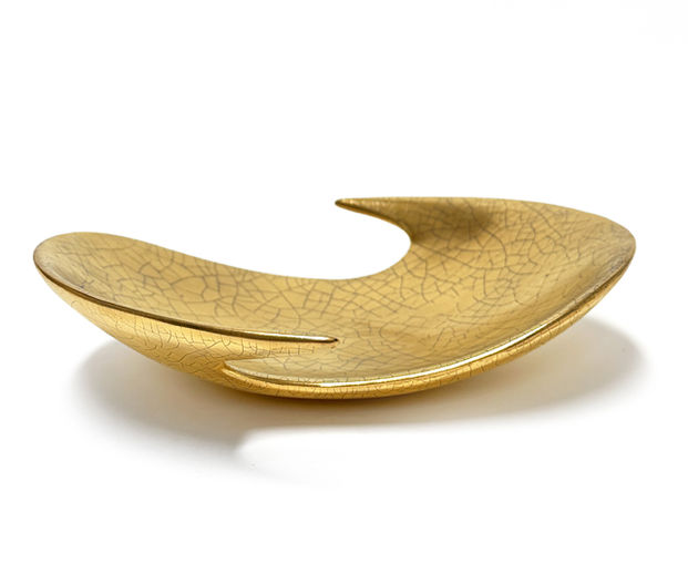 Low Profile Dish ceramic centerpiece featuring a fluid asymmetrical form and luminous 22k gold finish. Handcrafted decorative bowl with soft organic curves and a modern sculptural silhouette, designed as a luxury centerpiece for contemporary interiors.