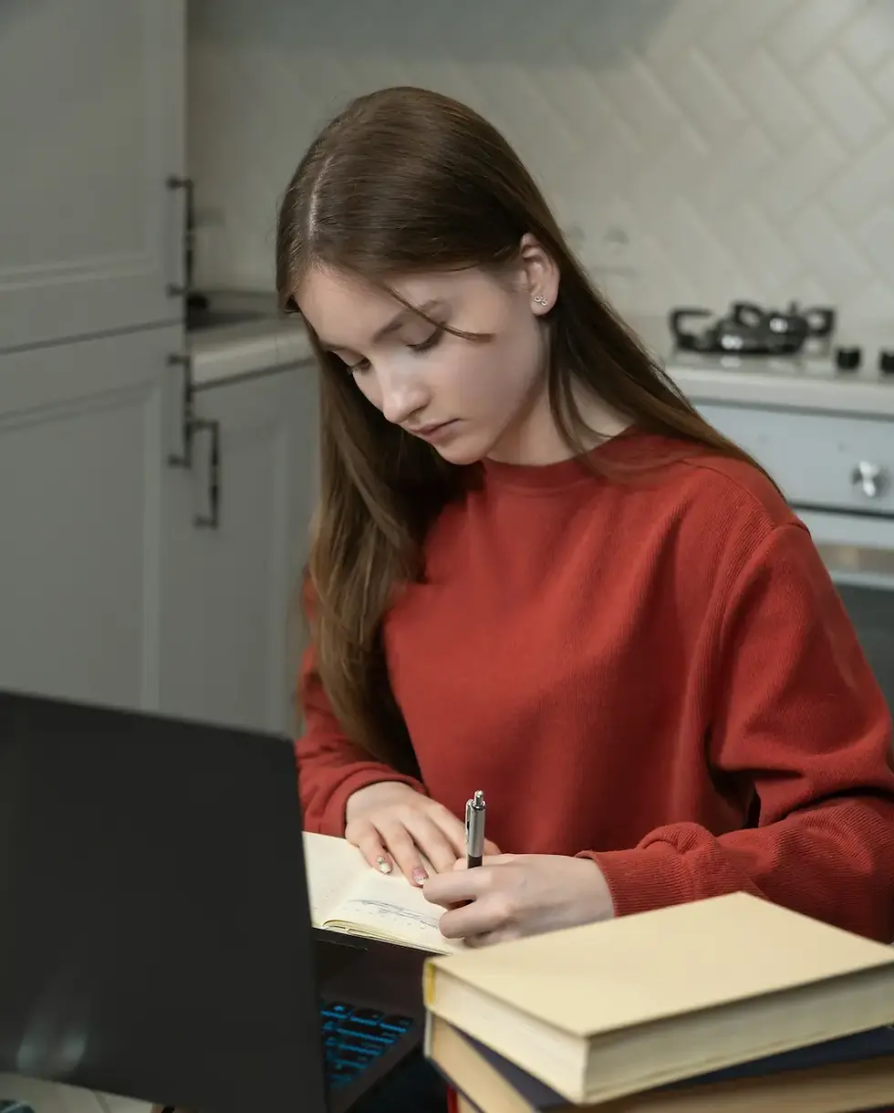 teenage girl studying at home
