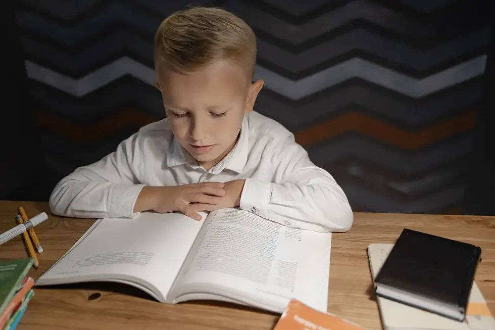 Boy reading difficult book