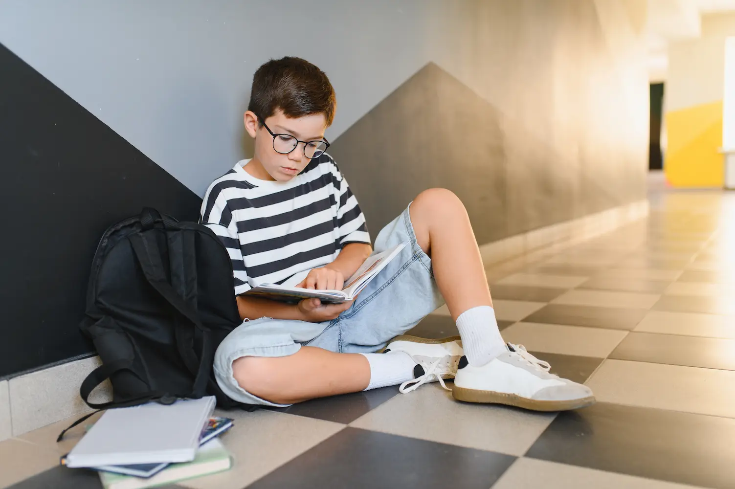 boy reading in hallway