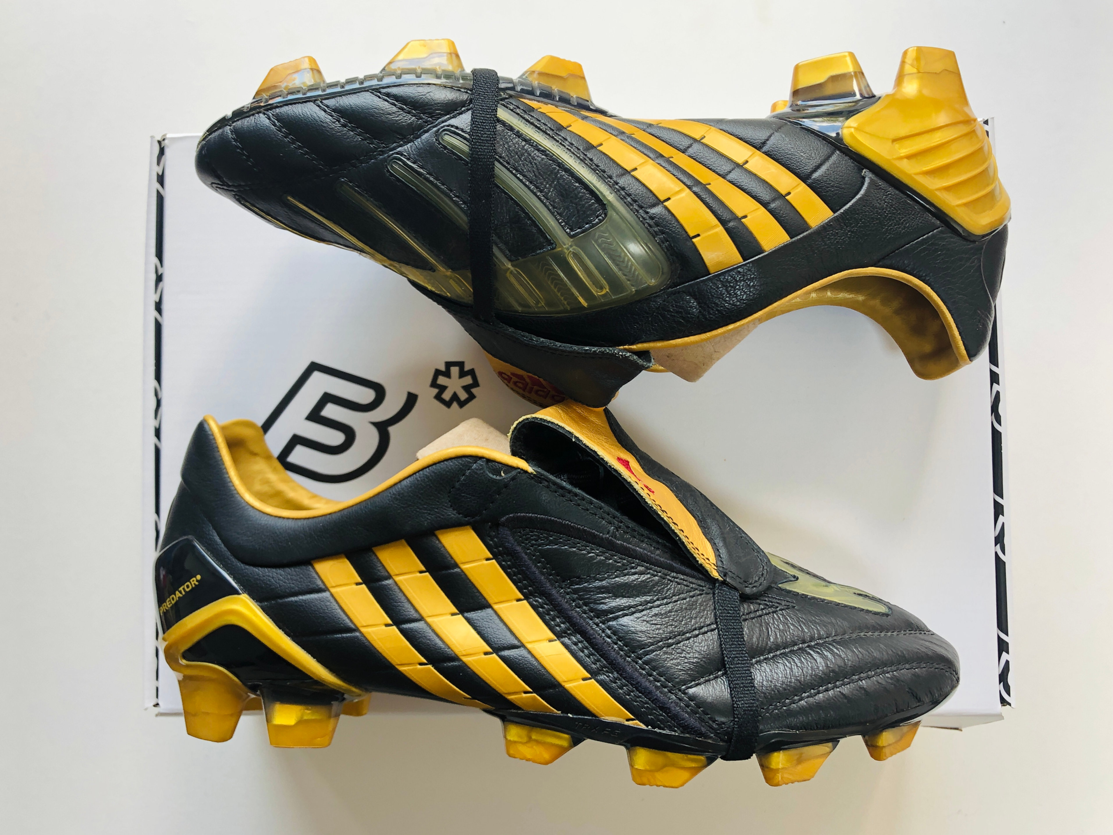 black and gold predator boots