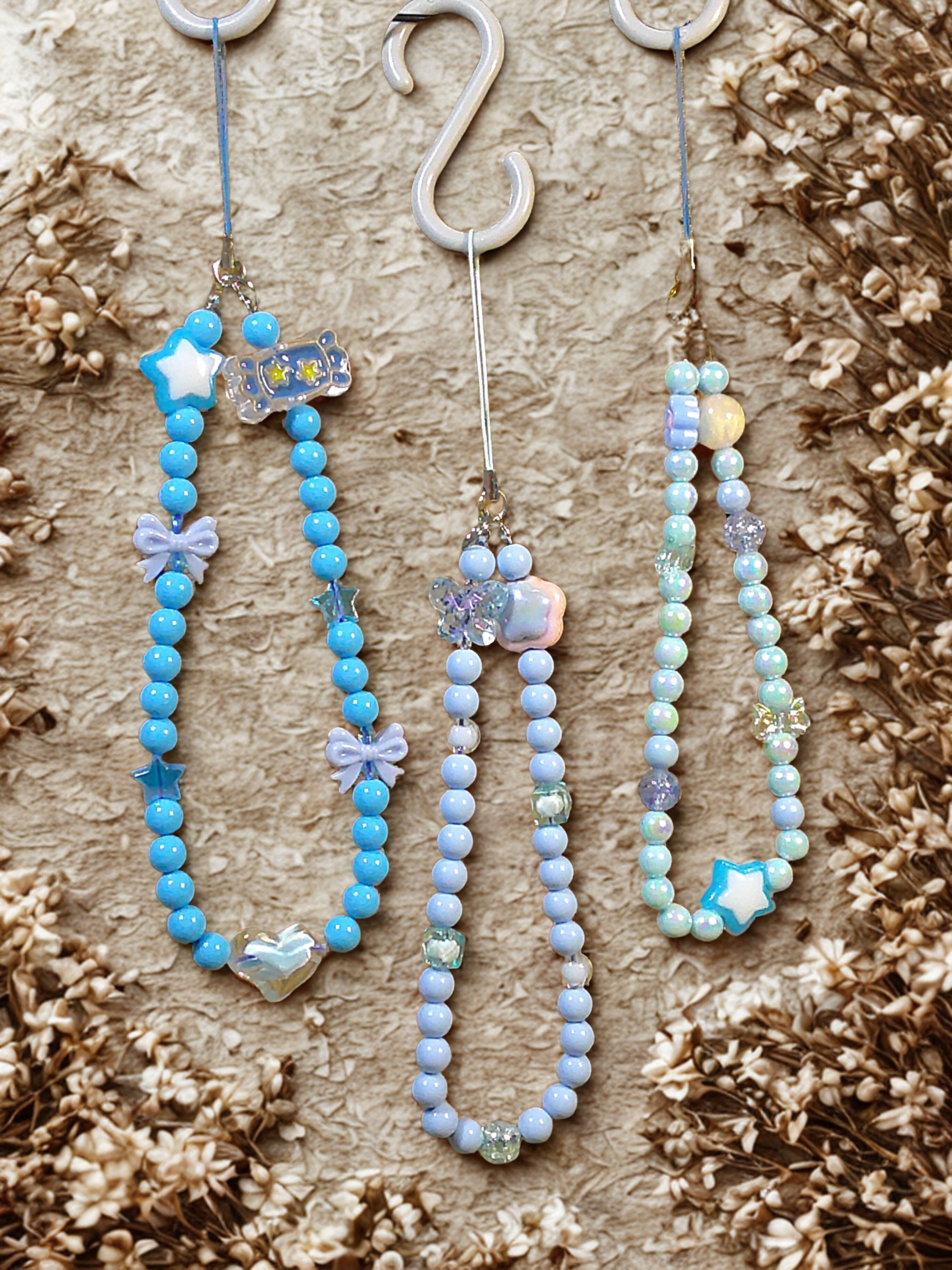 THREE ASSORTED BLUE PHONE CHARMS