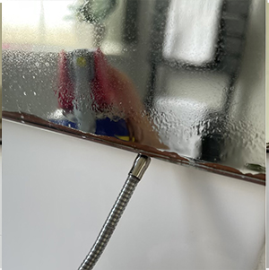 WD40 being used to repair mirror desilvering on a bathroom mirror