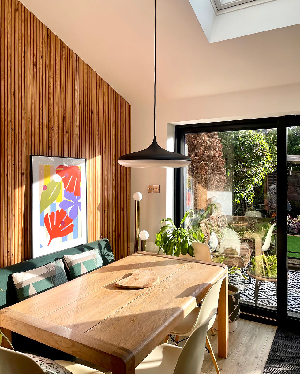 wooden dining table in dining room with panelled wall and chandelier