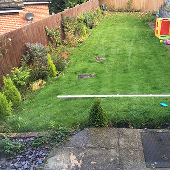 sloped backyard before decking installed