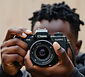BLACK PERSON TAKING SNAPSHOT CAMERA.jpg